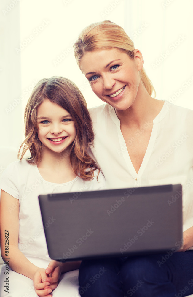 smiling mother and little girl with laptop at home smiling mother and little girl with laptop at home