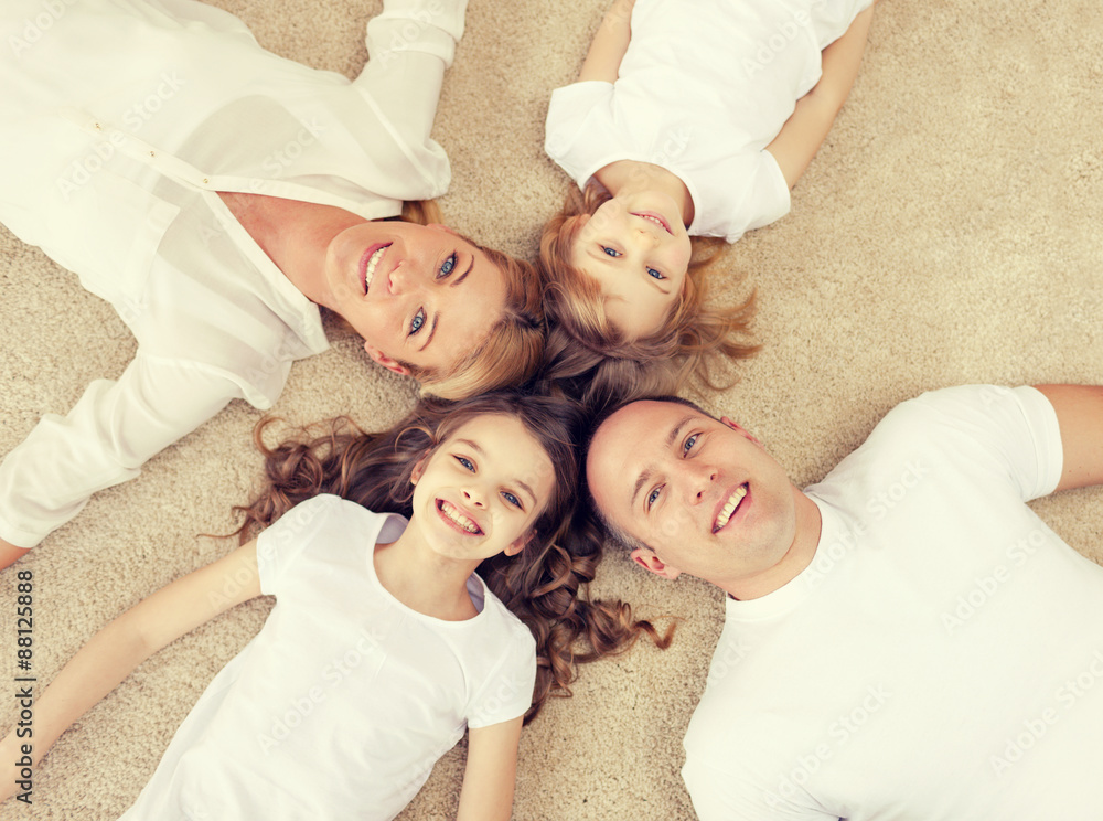 parents and two girls lying on floor at home