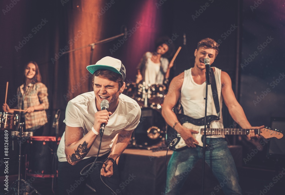 Naklejka premium Multiracial music band performing on a stage