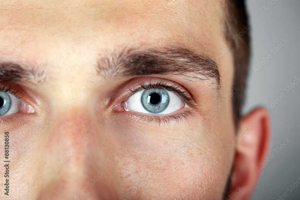 Fototapeta premium Beautiful blue man eyes close up