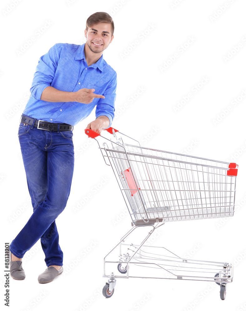 Young man with empty shopping cart, isolated on white Young man with empty shopping cart, isolated on white