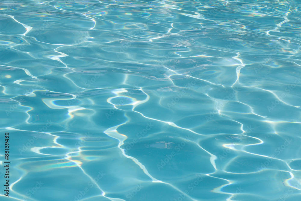 Blue pool water with sun reflections Blue pool water with sun reflections