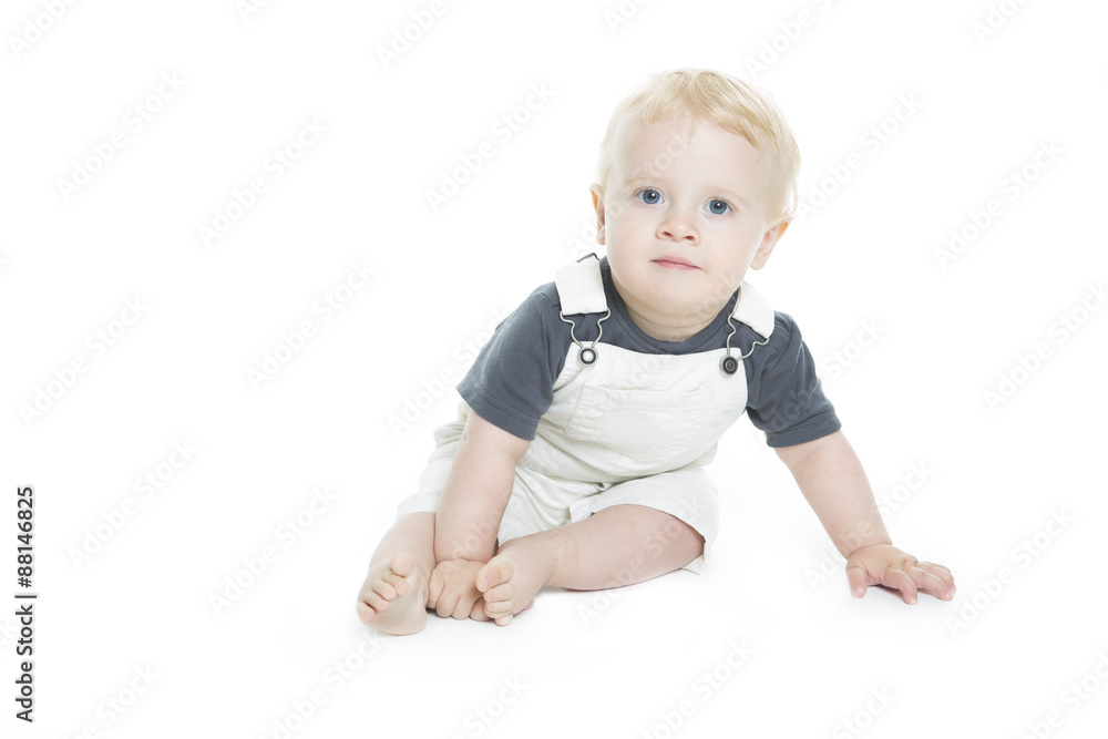 Cute baby with big blue eyes in denim on white background. Cute baby with big blue eyes in denim on white background.