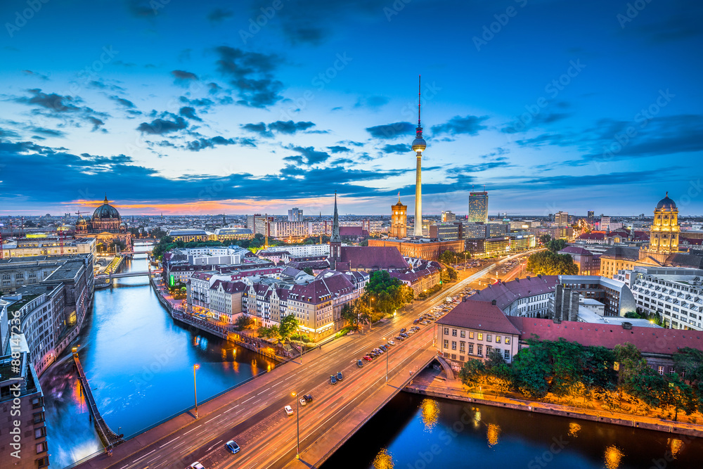 Berlin skyline panorama with dramatic clouds in twilight at dusk, Germany