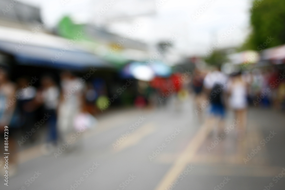 Blurred background : people shopping at market fair in sunny day