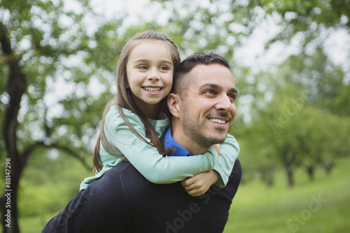 Father and daughter in forest on a meadow