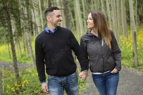 Young happy couple in the forest meadow