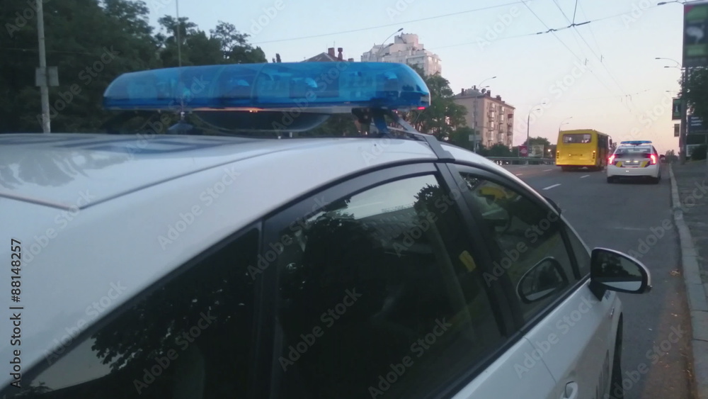Closeup blue flashing police lights on top of patrol car, crime scene, emergency Closeup blue flashing police lights on top of patrol car, crime scene, emergency