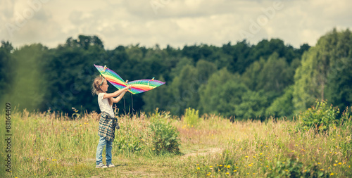 little cute girl flying a kite 