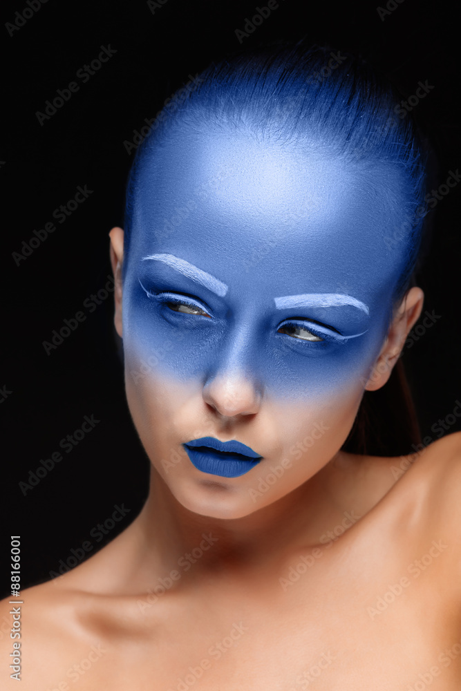 Portrait of a woman who is posing covered with blue paint Portrait of a woman who is posing covered with blue paint