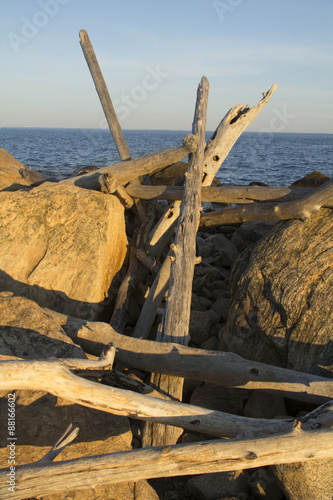 Stack of driftwood among rocks of Hammonasset Beach, Connecticut photo