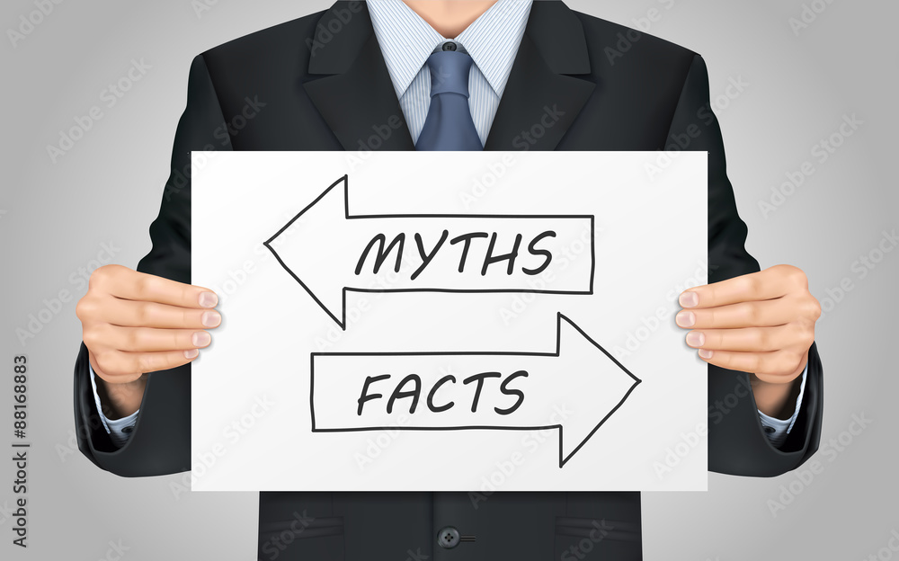 businessman holding myths or facts poster businessman holding myths or facts poster