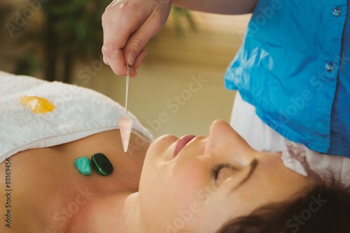 Young woman at crystal healing session photo