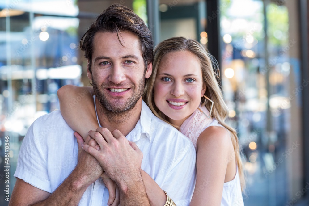 Smiling woman putting arm around her boyfriend Smiling woman putting arm around her boyfriend