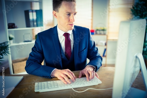 Stylish businessman working at his desk