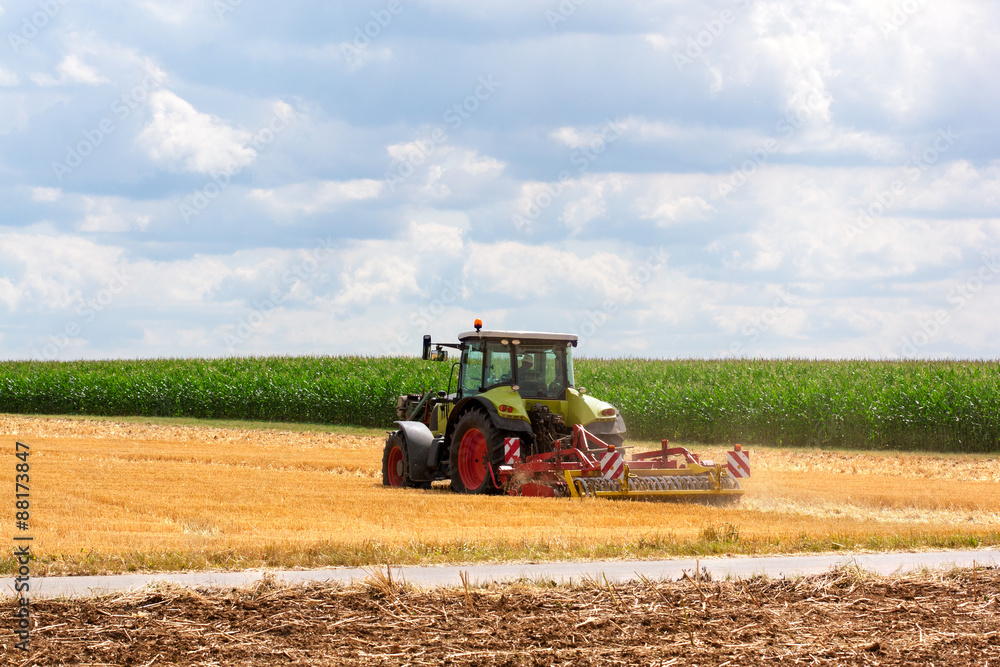 Agriculture - tractor ploughing at the field Agriculture - tractor ploughing at the field