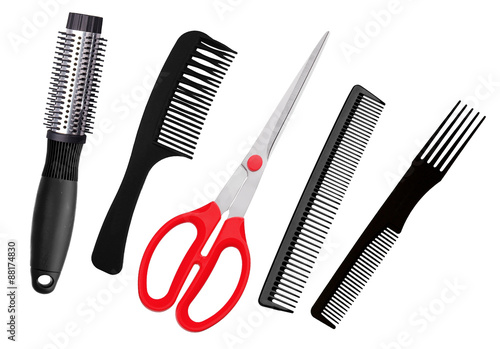 Red scissors and combs isolated on white