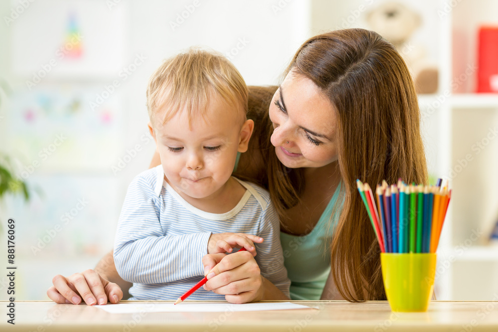 cute child drawing with mother help cute child drawing with mother help