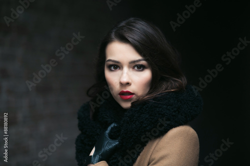 Charming fashion female modell in a coat. © teksomolika