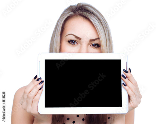 Young cheerful woman is showing blank tablet.