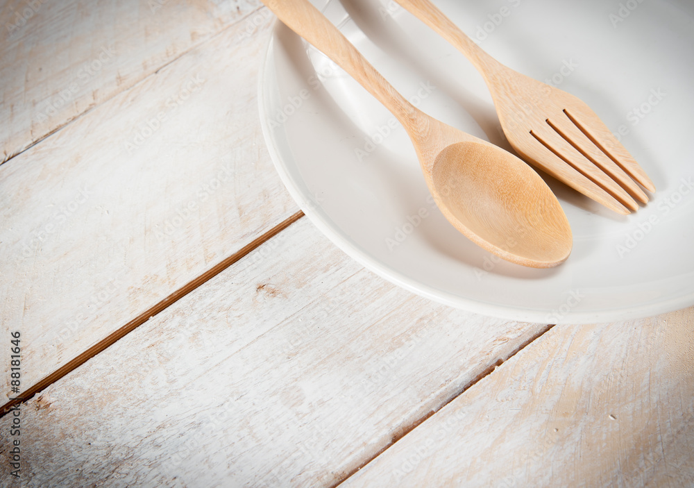 plate with fork and spoon on wood ,with shadows plate with fork and spoon on wood ,with shadows