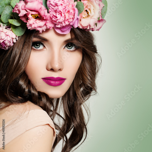 Beautiful Girl with Flowers Wreath. Long Permed Curly Hair and F