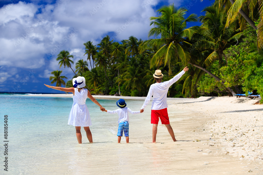 happy loving family with small kid on tropical beach