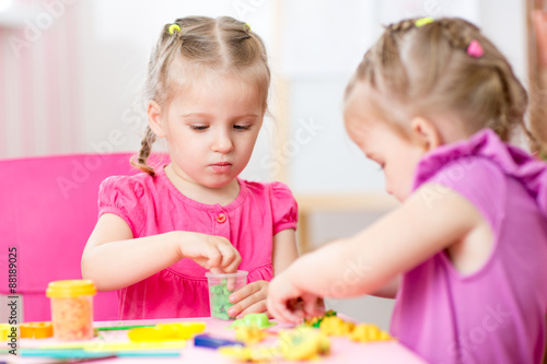 children girls play with colorful clay