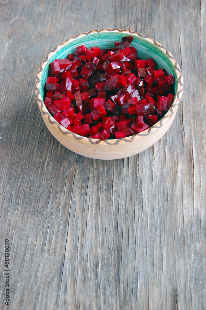 fresh beetroot salad in ceramic bowl on rustic wooden table fresh beetroot salad in ceramic bowl on rustic wooden table
