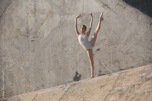 Fotografie Slim dancer sits in a ballet pose
