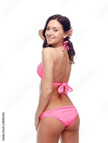 happy young woman in pink bikini swimsuit