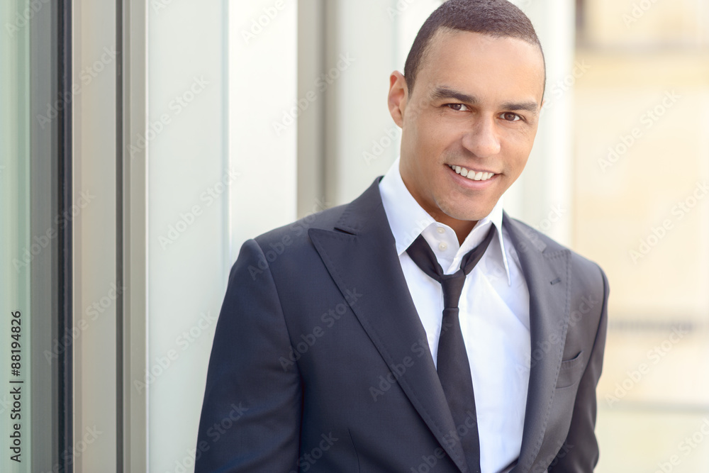 Attractive smiling businessman with a loosened tie Attractive smiling businessman with a loosened tie