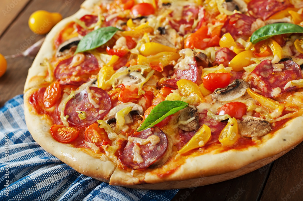 Pizza with salami, tomato, cheese and mushrooms