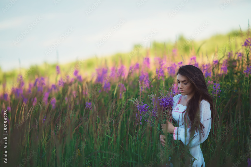 Girl is looking charming look, long shiny hair in lavender field Girl is looking charming look, long shiny hair in lavender field