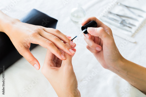 Manicurist applying cuticle softener