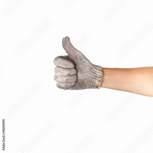 hand in dirty work gloves with thumb up isolated on white backg