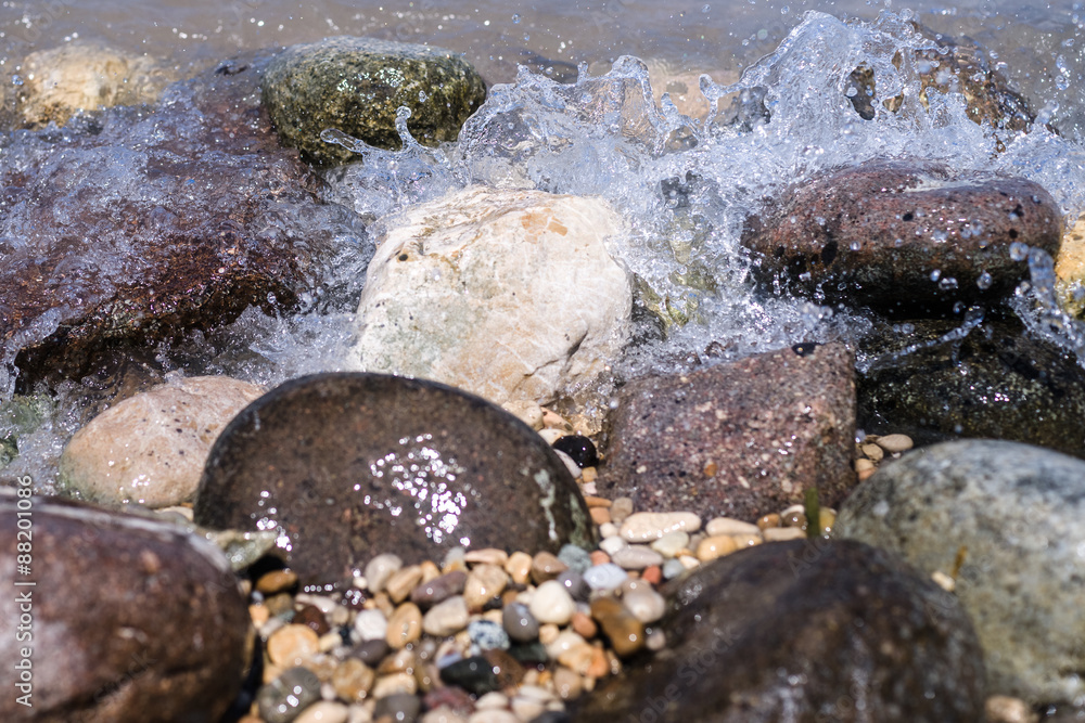 Colorful Rocks with splashing waves on a Beach Colorful Rocks with splashing waves on a Beach