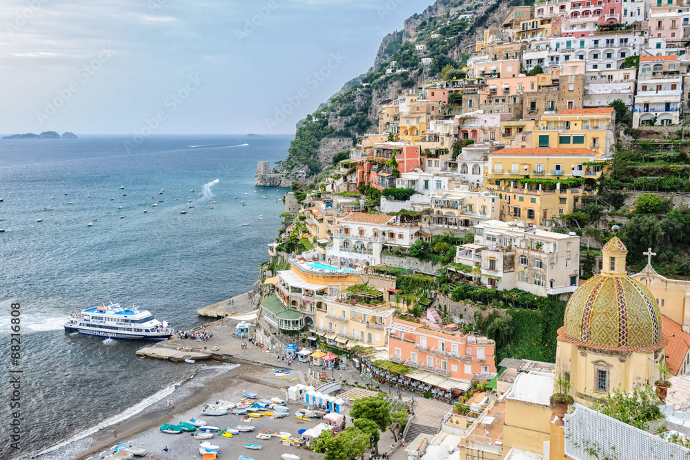 POSITANO, ITALY- SEPTEMBER 30, 2012: Evening ferry boat arrives in Positano. Ferry service along the Amalfi coast is a popular form of transport for tourists and locals during the summer months.