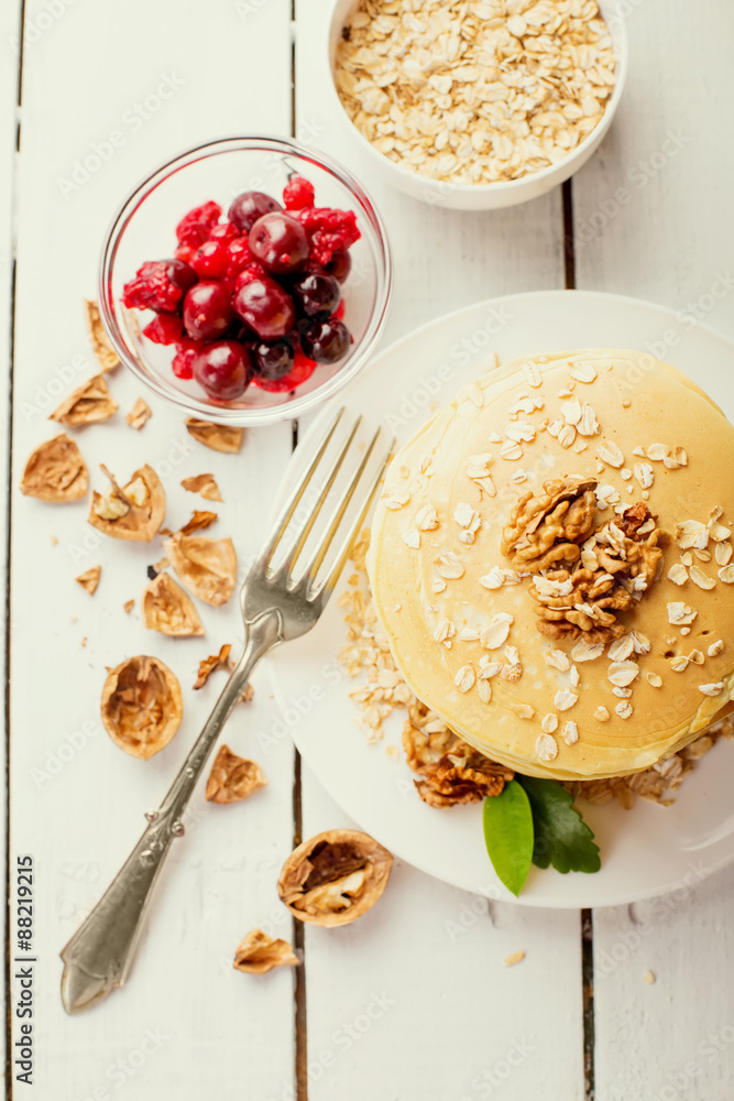 delicious pancakes on a wooden table with nuts delicious pancakes on a wooden table with nuts