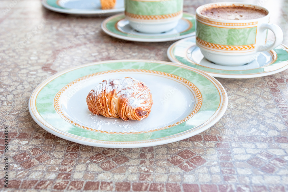 Sfogliatelle, a sweet pastry, with Cappucino coffee. Typical continental breakfast served in Sorrento, Campagnia, Italy.