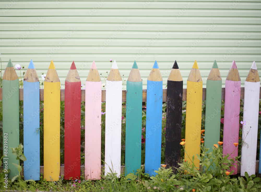 fence of colored pencils. the fence in the garden of multi-colored planks in the form of pencils fence of colored pencils. the fence in the garden of multi-colored planks in the form of pencils