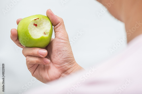 Asian man bite green apple and scurvy photo