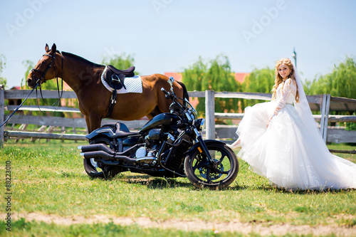portrait of a beautiful bride and horse and black motorcycle