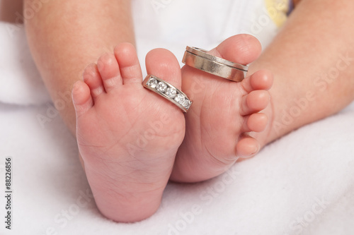 Baby feet with wedding rings parents