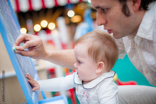 Image of cute little daughter with her young dad