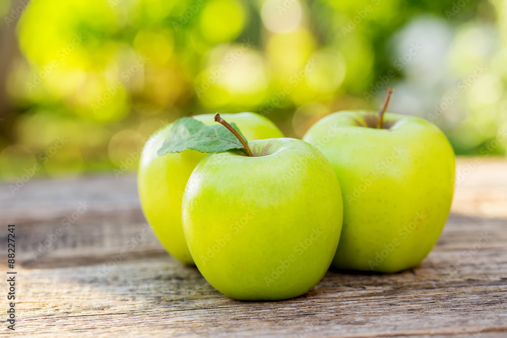 Ripe apples on wooden table, on nature background Ripe apples on wooden table, on nature background