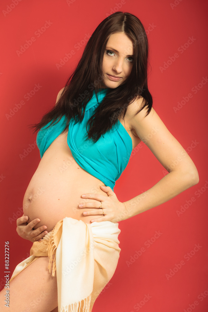 Attractive pregnant woman touching her belly Attractive pregnant woman touching her belly