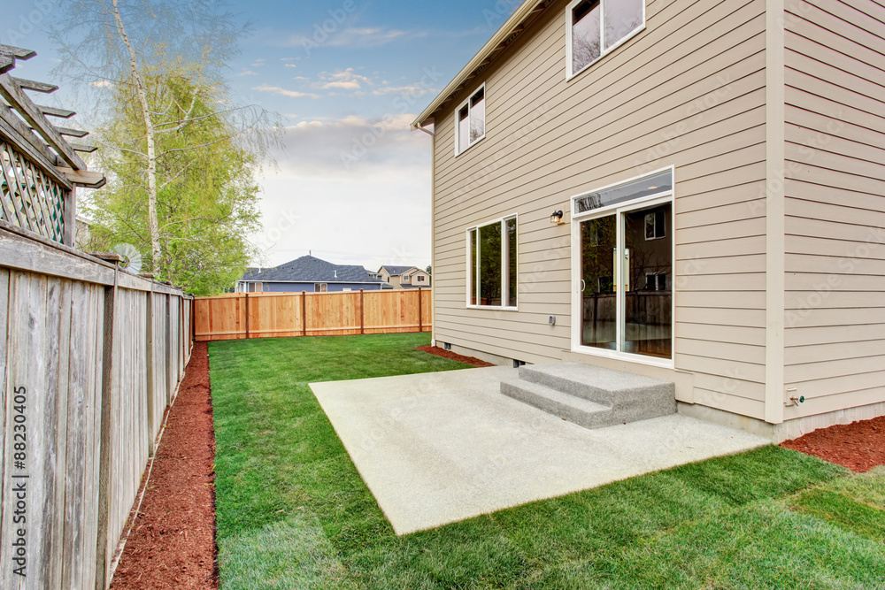 fenced and unfurnished back yard with grass. - obrazy, fototapety, plakaty 