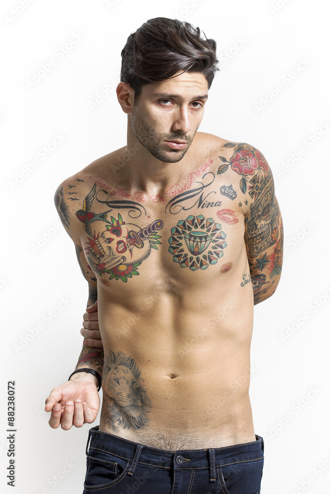 Fototapeta premium Handsome and sexy tattooed man portrait looking at camera