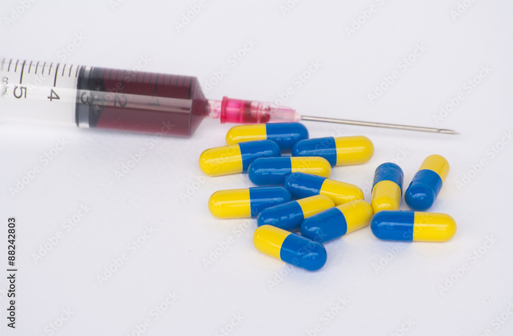 Syringes, capsules and tablets. On a white background. blur.